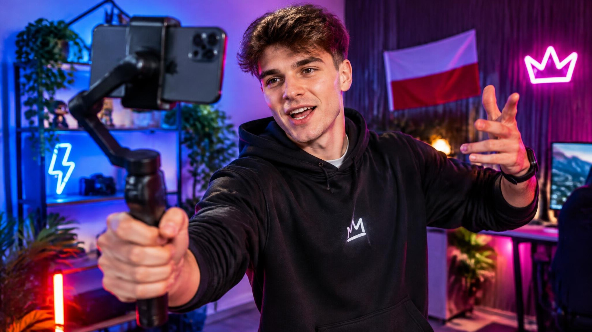 Young creator filming a dynamic vertical video with colorful lighting