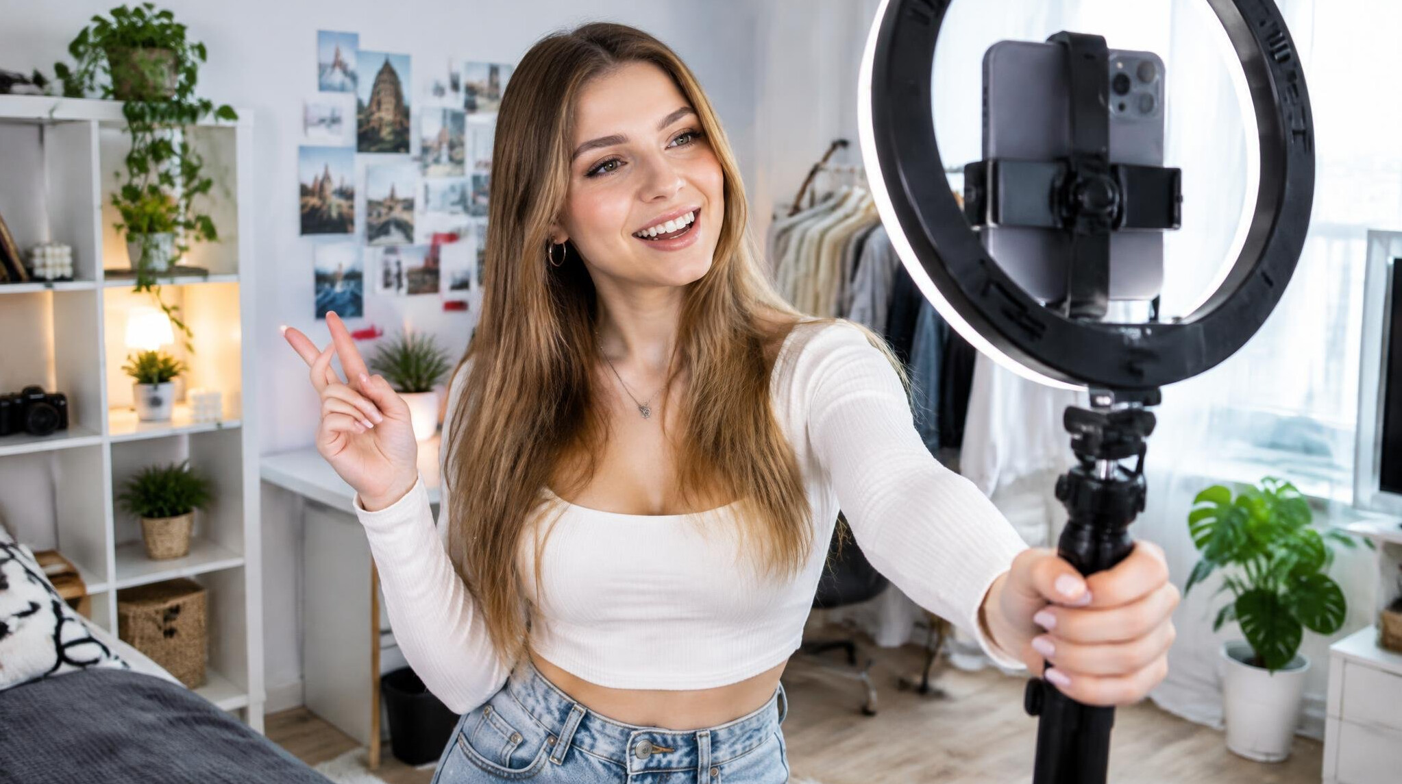 Young content creator filming vertical video with smartphone and ring light